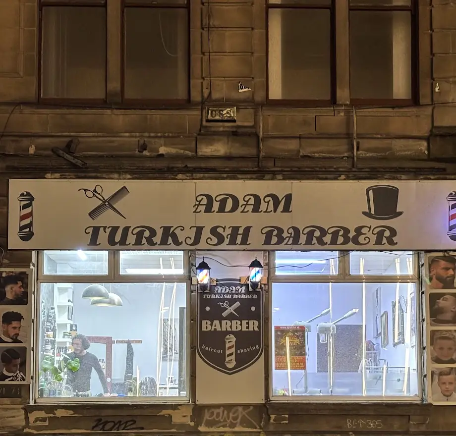 Adam Turkish Barber illuminated shopfront at night, Kingston Street, Kinning Park, Glasgow